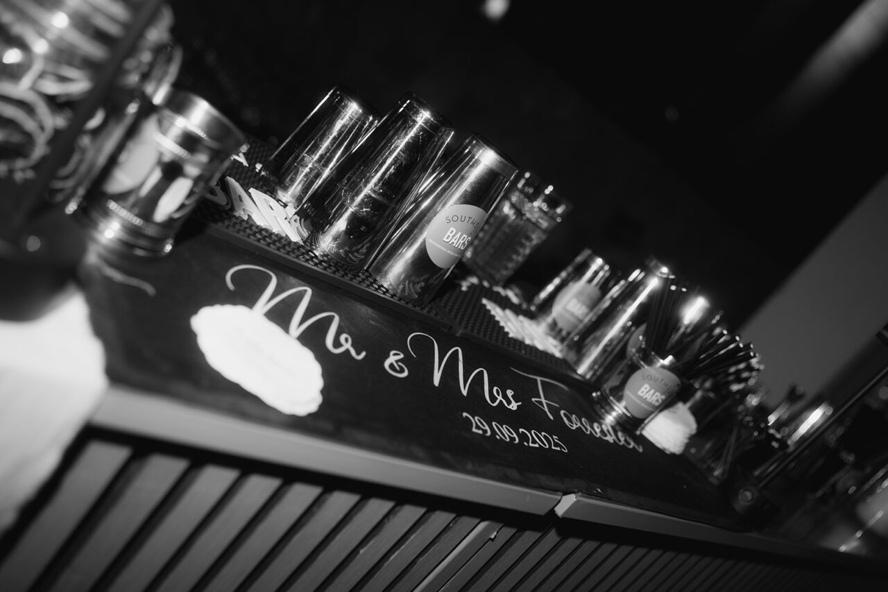 A bar set up with cocktail shakers and a bar mat