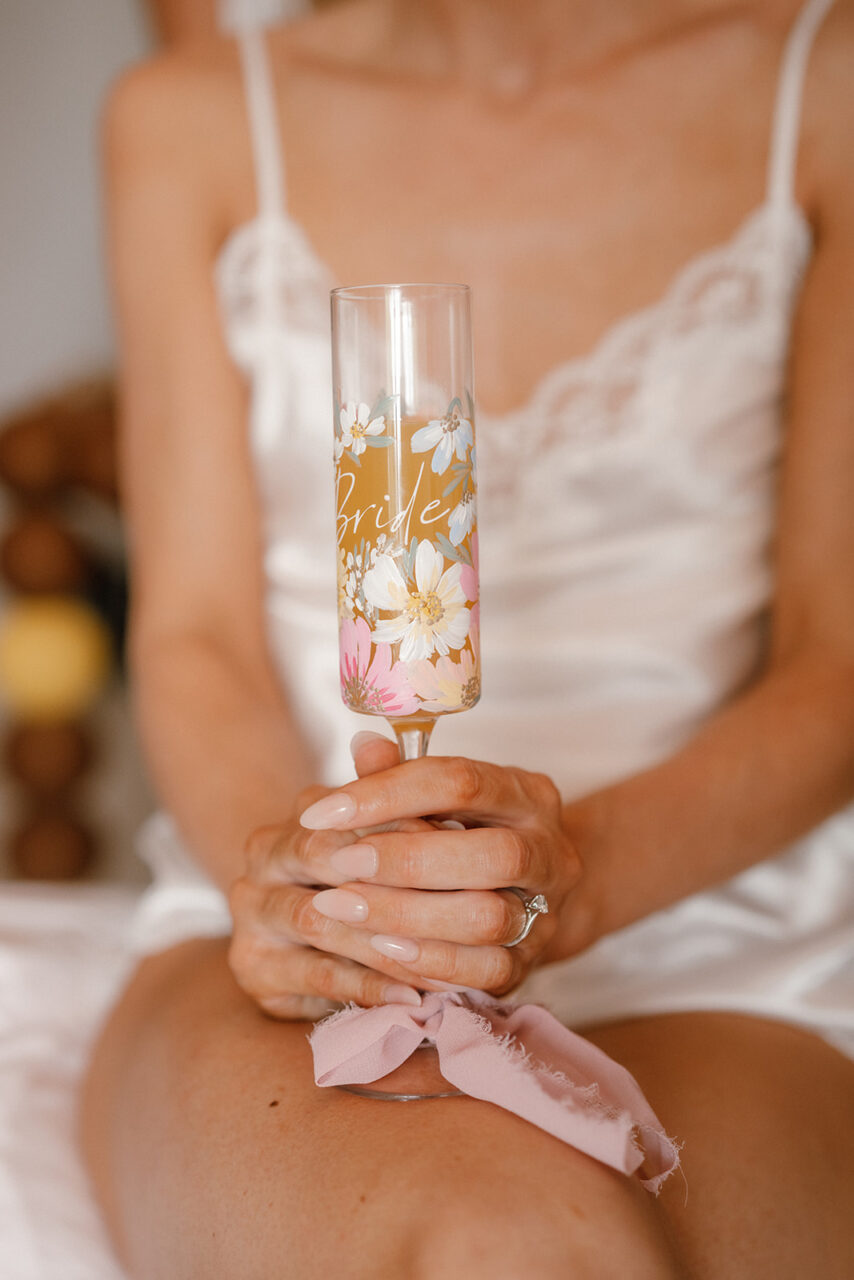A lady holding a champagne flute.